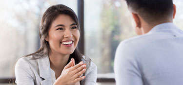 woman looking at man as they discuss something