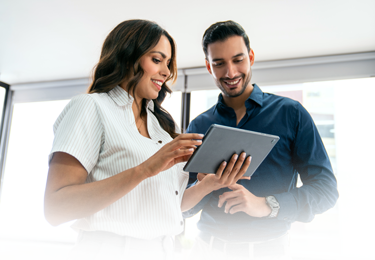 Man looking up from computer with smile