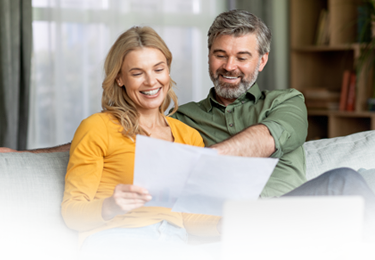 Couple sitting on a wall looking up