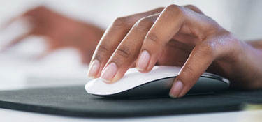 Close up of woman controlling computer mouse.